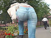 Tight blue jeans are wrapping the perfect booty of this sexy girl walking down the street and having no idea her back view is shot.