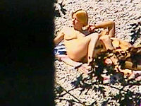 The guy with hidden camera is sitting in the bushes and shooting the sexy couple of horny nudists!