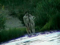 A couple of real nudists was spied by our cameraman when they were going to pound the naked skin into the lake water