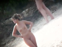 Two sweet naked babes are getting the hot nudist fun on the beach having no clue their pastime is getting voyeured on camera