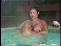 Relaxing in Jacuzzi the chick pulls her bikini bra from the tits and her partner can