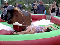 The cute cow girl is enjoying the pastime in the entertainment park and when she is riding the bull she tries to do her best not to fall down and thus doesn't pay attention on the skirt that is already lifted up uncovering the nasty upskirt