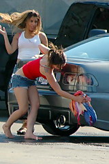 Car upskirt. Sexy babe washes a car and flashes