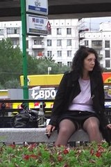 Marina in black skirt on a bench