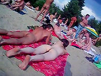 These nudists at beach are lying in the hot summer sun enjoying the rays warming their absolutely nude bodies!