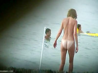Milky white titties and butt cheeks of this nudist woman look great when she is entering into the ocean