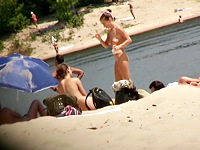 Nude public is on the beach enjoying the hot sun rays petting the natural bodies and getting kinkily recorded on the voyeur cam of our hunter